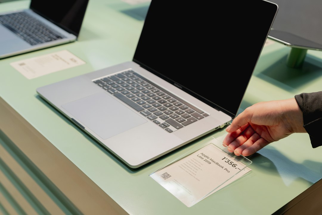 An open laptop displaying an itemized checkout screen of a vacation rental booking with multiple fees listed.